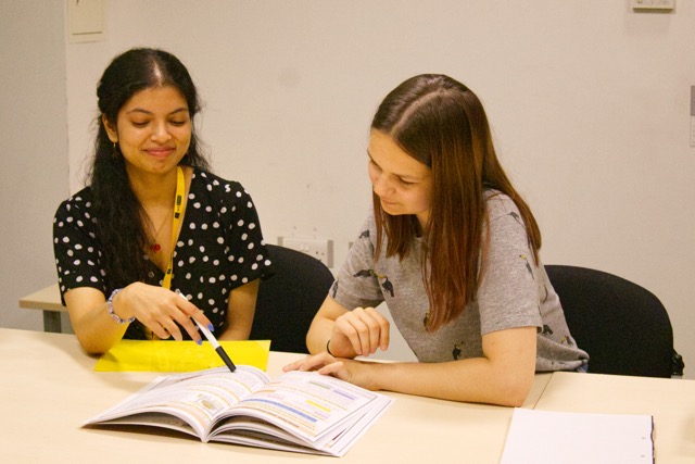 NSEMM tutor working with a student during a session