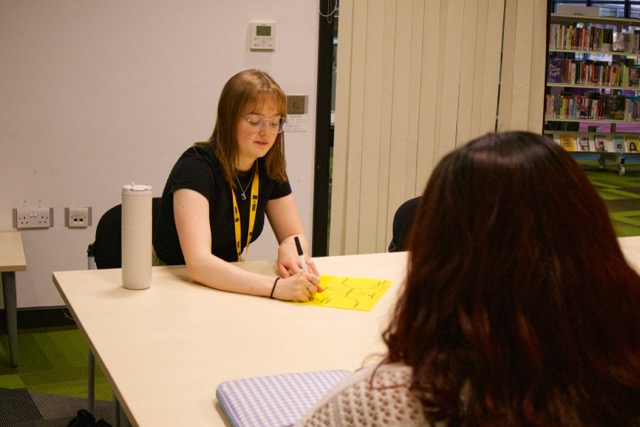 Students working with tutor in school setting